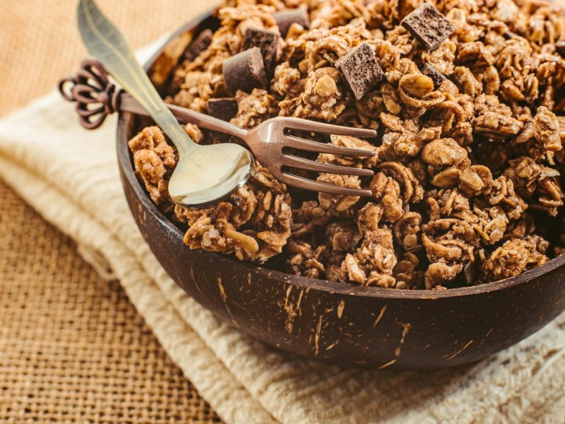 A wooden bowl full of muesli for the snack of athletes who want to keep fit.